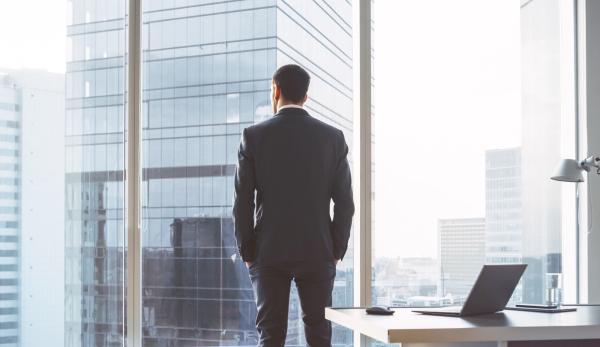 back-view-of-a-man-standing-in-office
