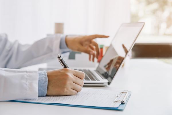 A doctor working with the computer