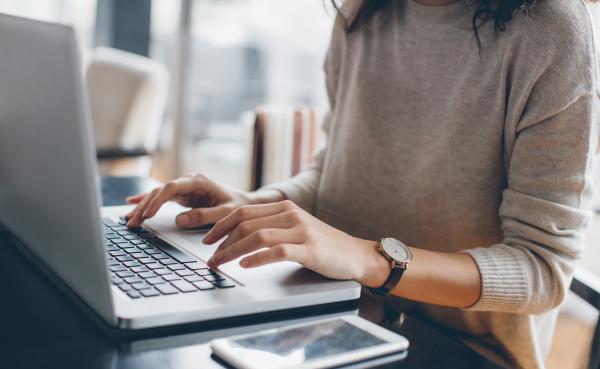 woman typing on a laptop