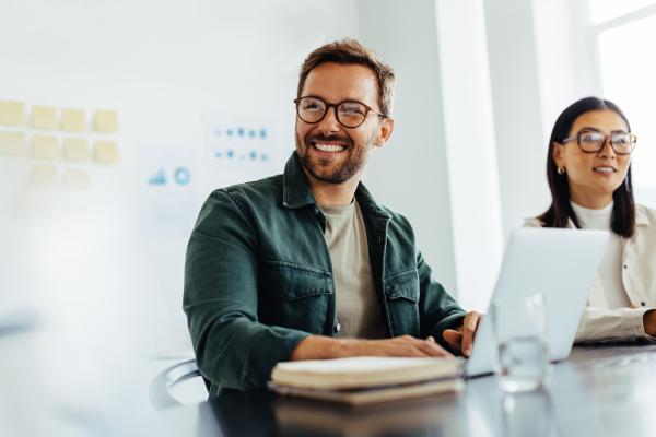 man working on his laptop smiling