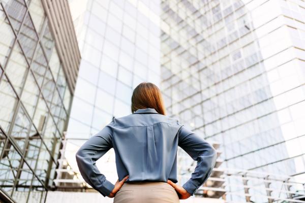 back view of a woman standing in front of an office building