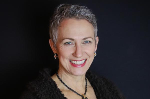 woman with white short hair smiling