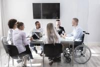 equality-at-work-concept_man-in-wheelchair-in-a-group-meeting