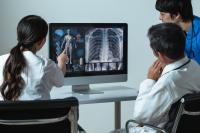 group of doctors checking a screen