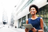 woman smiling holding an ipad