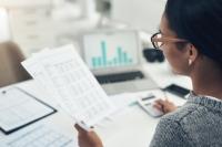 woman holding some papers while working